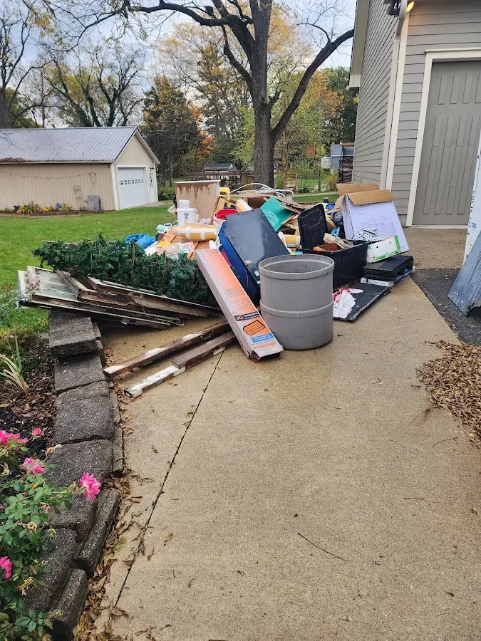 Dumpster being loaded with debris for 12 Yard Dumpster Rental in Mosinee